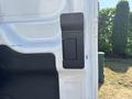 Close-up of a white 2019 Ford Transit 350 door hinge with a rectangular latch mechanism