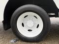 Close-up of a white wheel with a six-bolt pattern and black tire on a 2018 Ford E-450