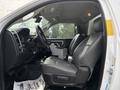 Interior view of a 2016 RAM 5500 showing black leather seats and dashboard with controls and storage compartment in the center console