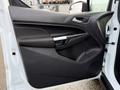 A 2017 Ford Transit Connect door panel featuring a sleek design with controls for windows and locks a speaker and a textured surface