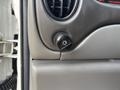 The image shows a close-up of a black knob with a light symbol used to control interior lighting on the dashboard of a 2008 Ford Econoline