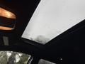 Sunroof of a 2019 Jeep Grand Cherokee showing rain droplets on the glass with a cloudy sky visible through the opening