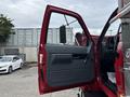 A 2002 GMC C7500 truck with the driver's side door open showcasing the interior panel and handle
