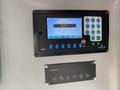A control panel featuring a screen with text and various buttons including a numeric keypad and operational controls