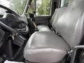 Interior view of a 2012 International TerraStar showing two grey leather seats and a steering wheel with a gear shift and controls