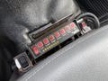 Control panel with several red buttons labeled for various functions and a row of indicator lights