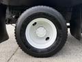 Close-up of a white wheel and tire on a 2008 International 4300 truck featuring a Michelin tire with visible tread and rim details