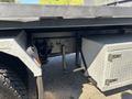 A 2020 Peterbilt 330 featuring a silver diamond plate storage box and a visible undercarriage support with black metallic components