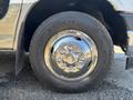 Close-up of a chrome wheel with a shiny hubcap and a black tire featuring visible tread patterns on a 2020 Chevrolet Express