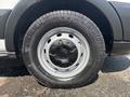 A close-up of a wheel on a 2019 Ford Transit 350 featuring a black tire with a silver wheel rim