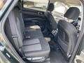 Interior view of the backseat of a 2022 Kia Sorento showing two rows of seats with black fabric upholstery and a center armrest