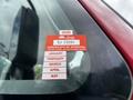A red sticker on a vehicle window displaying the year 2026 and the text "Certificate of Approval" along with months listed from January to May