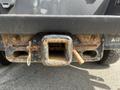 A close-up view of a rusty hitch receiver attached to the rear of a 2017 Ford F-250 SD