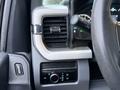 Close-up of the dashboard controls in a 2023 Ford F-250 including air vents a dial for settings and a lever for controlling headlights