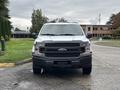 2020 Ford F-150 pickup truck facing forward with a silver body and black grille