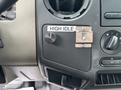 A 2010 Ford F-550 Super Duty dashboard control panel featuring a high idle switch with a knob and labeled metal bracket