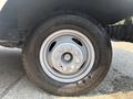 A close-up view of a steel wheel and tire from a 2018 Ford Econoline showing a five-bolt pattern and rugged tread design