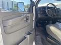 Interior view of a 2011 Chevrolet Express showing the driver's door panel and dashboard with controls