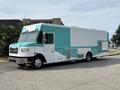 A teal and white 2020 Freightliner MT45 delivery truck with a large cargo area and side entry door