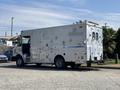 A 2008 Workhorse W62 is parked with a large boxy cargo area featuring multiple compartments and a roof-mounted light bar