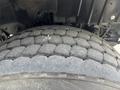 Close-up of a large tire from a 2013 International WorkStar showcasing a thick tread pattern and surface wear