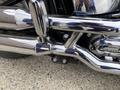Close-up of a polished chrome exhaust system on a 2008 Harley-Davidson FLSTFI showcasing intricate details and reflective surfaces