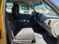 Interior view of a 2013 Chevrolet Silverado 1500 showing the driver's side with a black fabric seat and a center console