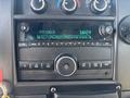 The dashboard of a 2020 Chevrolet Express showing a radio display with FM frequency and control knobs