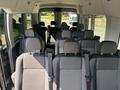 Interior view of a 2025 Ford Transit T-350 showing rows of black fabric seats with headrests and seat belts