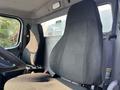 Interior view of a 2016 Freightliner M2 106 with two fabric seats and a steering wheel visible in the foreground