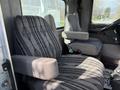 Interior of a 2008 Kenworth T370 with two gray seats featuring a striped fabric pattern and armrests
