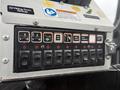 Control panel with various toggle switches and indicator lights for functions like spot light and engine warnings on a 2016 Freightliner 108SD