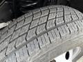 Close-up of a worn tire tread from a 2002 Ford Econoline showing intricate patterns and texture of the rubber surface