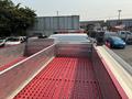 A 1999 Freightliner FL80 truck viewed from above showing a red bed with metal sides and a flat surface ready for loading