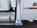 White 2008 Kenworth T370 truck with visible exhaust and side steps featuring a warning label indicating caution