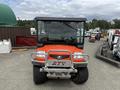 A 2011 Kubota RTV 1140 CPX utility vehicle with a front windshield and grille guard positioned in the foreground