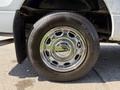 A chrome wheel rim with a black tire marked with the brand name and tread pattern of a 2014 Ford F-150