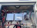 A 2011 Chevrolet Express with visible electrical components including two control modules and a fuse panel connected by colorful wires