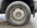 A close-up of a 2017 Ford F-450 Super Duty wheel featuring a steel rim and all-terrain tire with visible tread patterns and a prominent logo