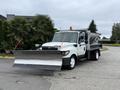 2012 International TerraStar equipped with a snow plow attachment and a salt spreader in the truck bed, facing forward with a clear view of the front and plow