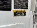 A caution label on a 2008 Ford F-550 indicating a platform capacity of 350 lbs without liner