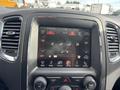 Interior dashboard of a 2015 Dodge Durango featuring a central touchscreen display with climate controls and audio settings