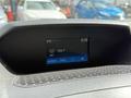 Dashboard display of a 2016 Ford Transit showing time temperature radio station and menu options