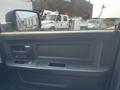 Interior view of a 2015 RAM 1500 door with controls for windows and locks visible on the armrest