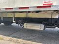 A 2018 Hino 195 with a visible exhaust system and undercarriage detailing showing the chassis and suspension components