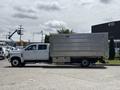 A white 2020 Chevrolet Silverado truck with a metal box bed parked on a concrete surface