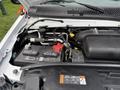 Engine compartment of a 2022 Ford E-450 showing the battery and various components including hoses and connectors