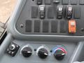 Dashboard controls of a 2013 International 4300 including switches for lights temperature and air conditioning