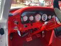 Interior dashboard of a 1962 Ford 2WHDR featuring red accents analog gauges and a steering wheel with a shiny metal rim