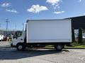 A side view of a white 2014 Hino 195 box truck with a closed cargo area and no visible markings or logos
